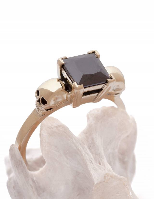 Black diamond skull ring for women made of solid gold.